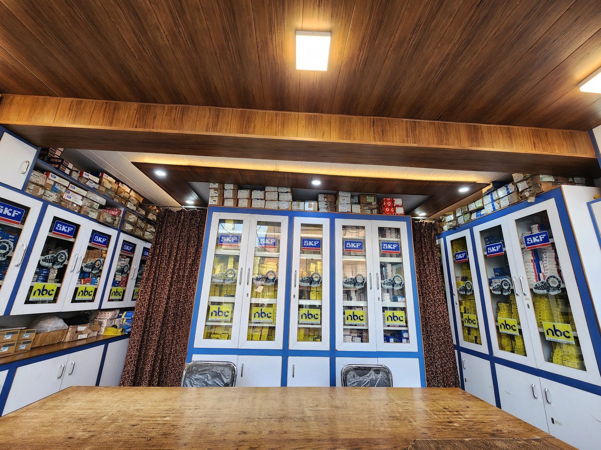 Inside Padam Chand Bearing showroom showing brand-organized SKF and NBC bearing cabinets
