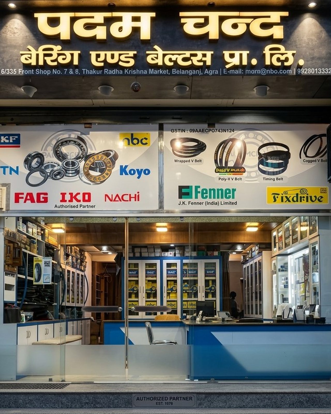 Padam Chand Bearing & Belts shopfront in Belanganj, Agra — illuminated Hindi signboard, authorized SKF, NBC, NTN, Koyo, FAG, IKO, Nachi, JK Fenner and Fixdrive brand displays, established 1978
